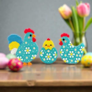 May include: Three beaded Easter decorations: a rooster, a chick, and a hen. The rooster has a blue body with white daisy accents, a red comb, and yellow and blue tail feathers. The chick is yellow and the hen is blue with white daisy accents.