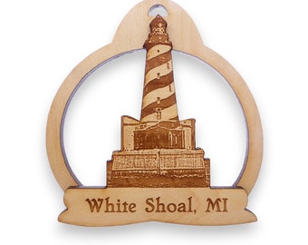 May include: Wooden ornament featuring a laser-engraved image of the White Shoal Lighthouse in Michigan. The ornament is shaped like a circle with a banner at the bottom that reads "White Shoal, MI".