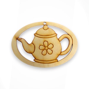 May include: A wooden cutout of a teapot with a flower design. The cutout is in the shape of an oval and has a hole at the top for hanging.