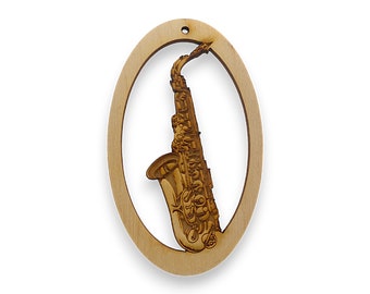 May include: A wooden oval ornament with a laser-cut design of a saxophone. The ornament is light brown in color and has a hole at the top for hanging.
