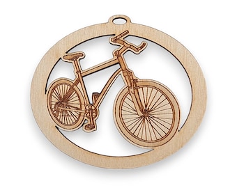 May include: A wooden ornament shaped like a circle with a laser-etched image of a bicycle inside. The ornament is made of light brown wood and has a hole at the top for hanging.
