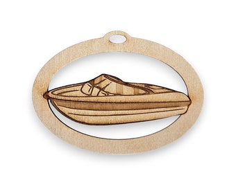 May include: Wooden ornament shaped like an oval with a cutout of a speedboat inside. The ornament is made of light brown wood and has a hole at the top for hanging.