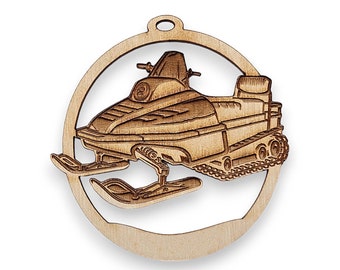 May include: A wooden ornament shaped like a snowmobile. The ornament is brown and has a white background.