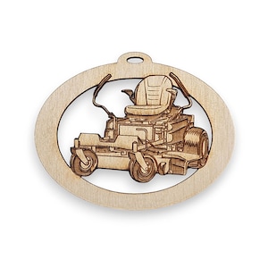 May include: A wooden ornament shaped like an oval with a laser-cut design of a riding lawnmower inside. The ornament has a hole at the top for hanging.