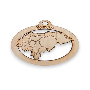 May include: Wooden cutout of the country of Honduras, with the country name "HONDURAS" printed at the top. The cutout is in the shape of the country's outline and includes the borders of each state.