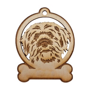 May include: A wooden ornament shaped like a dog's head with a bone hanging from the bottom. The dog's head is in a circle and the bone has a blank space for personalization.