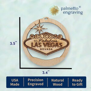 May include: A laser-engraved wooden ornament, 3.5 inches in diameter, featuring the iconic "Welcome to Fabulous Las Vegas" sign. The ornament is made of natural wood and includes a starburst design. The sign is 3.4 inches wide.
