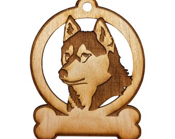May include: Wooden ornament featuring a Siberian Husky dog breed silhouette with a bone-shaped tag at the bottom. The ornament is brown and has a hole at the top for hanging.
