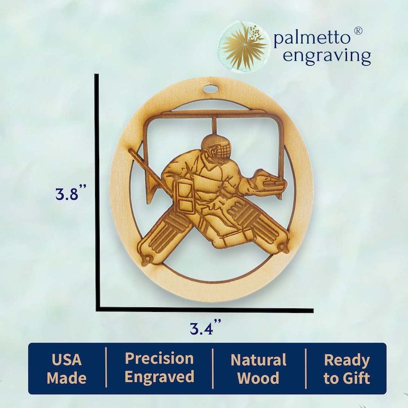 May include: A wooden hockey goalie ornament, 3.8 inches in diameter, with a detailed laser-cut design. The ornament is made of natural wood and is ready to be gifted. It features the text "palmetto engraving" in the top right corner.