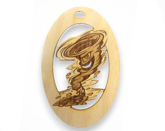 May include: A wooden oval ornament with a laser-cut design of a cartoon tornado with a face. The tornado is brown and has a white eye and a mischievous grin.