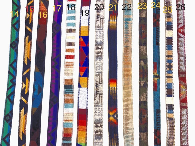 May include: Collection of woven belts with various geometric and tribal patterns. The belts feature a range of colors, including blue, green, red, and brown. Each belt has a unique design, showcasing intricate details and textures. The belts are displayed side by side.