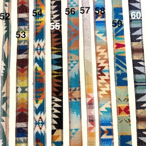 May include: A collection of woven ribbons with Southwestern-inspired geometric patterns. The ribbons feature various color combinations, including blue, orange, brown, and green, with a textured appearance. Each ribbon is numbered for easy selection.