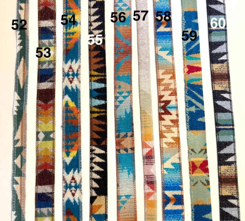 May include: A collection of woven ribbons with Southwestern-inspired geometric patterns. The ribbons feature various color combinations, including blue, orange, brown, and green, with a textured appearance. Each ribbon is numbered for easy selection.