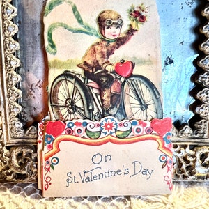 Vintage Made In Germany Fold Out Hand Colored Valentine Card "On St.Valentines Day"Boy Riding Bike Brown Head Gear & Goggles Holding Flowers