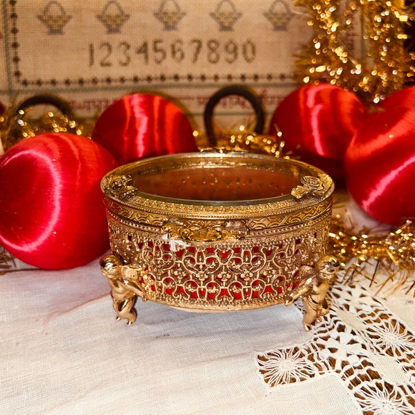 Stunning Hollywood Regency Gold with Cherubs Lidded Trinket Jewelry Oval Box with Glass Lid and Red Velvet Lined