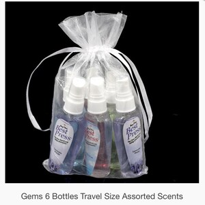 May include: Six small bottles of hand and body wash in a white organza bag. The bottles are clear and contain a variety of colours. The bottles are labelled "Best Press" and have a lavender scent.