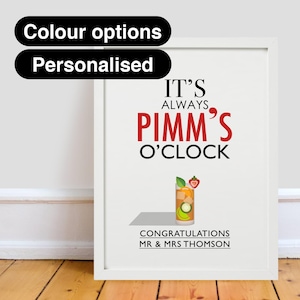 May include: White framed print with the text "It's Always Pimm's O'Clock" in black and red. A glass of Pimm's with a strawberry, cucumber, and orange slices is pictured. The text "Congratulations Mr. & Mrs. Thomson" is at the bottom.