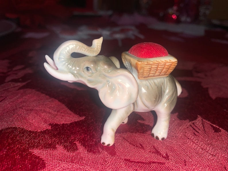 unique find! One is a pin cushion Enesco sticker on bottom of one Vintage elephant figurines