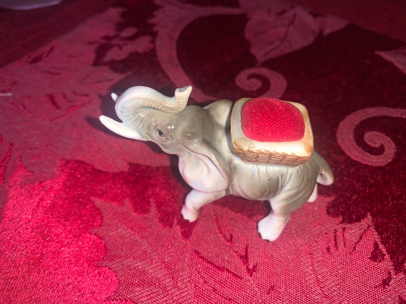 unique find! One is a pin cushion Enesco sticker on bottom of one Vintage elephant figurines