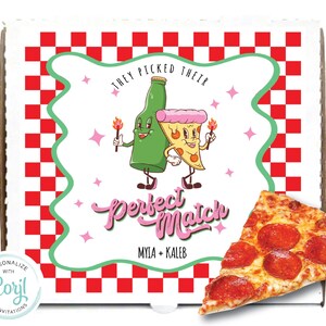 May include: A white pizza box with a red and white checkered pattern. The box has a cartoon image of a beer bottle and a pizza slice holding hands with the text "They picked their perfect match" and the names "Myla + Kaleb". A slice of pepperoni pizza is in the foreground.