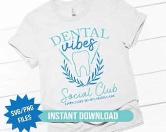 May include: White t-shirt with a blue and green design that says "Dental vibes Social Club Living Life to the Maxillary".