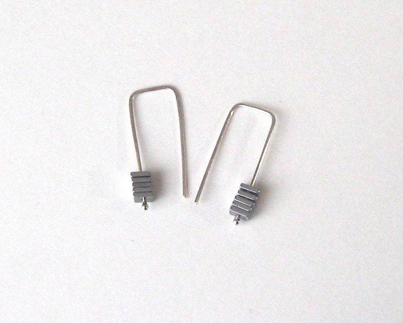 Staple silver earrings with metal coated hematite squares