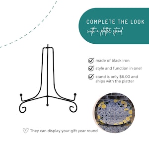 May include: A black iron platter stand with a decorative scroll design. The stand is designed to display platters and has the text "COMPLETE THE LOOK with a platter stand". The stand is made of black iron and can be used year-round.
