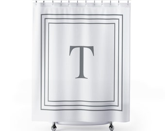 May include: White shower curtain with a gray border and a large gray letter "T" in the center.
