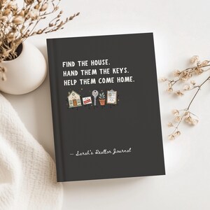 May include: A dark gray journal with the white text "FIND THE HOUSE. HAND THEM THE KEYS. HELP THEM COME HOME." and "- Sarah's Realtor Journal". Below the text are small cartoon illustrations of a house, a sold sign, a key, a plant, and a clipboard.