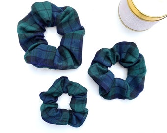 May include: Three green and blue plaid scrunchies of different sizes.