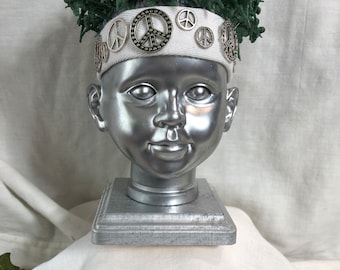 GIVE PEACE a CHANCE. Doll head mixed media assemblage sculpture