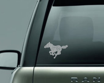 May include: A white, rhinestone-studded running horse silhouette decal for a car window.
