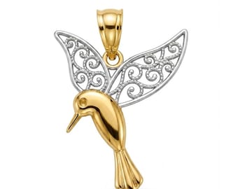 May include: A two-tone pendant shaped like a hummingbird. The bird's body, head, and tail are crafted from polished yellow gold, while the wings feature an intricate, openwork silver filigree design. A gold bail is attached to the top.