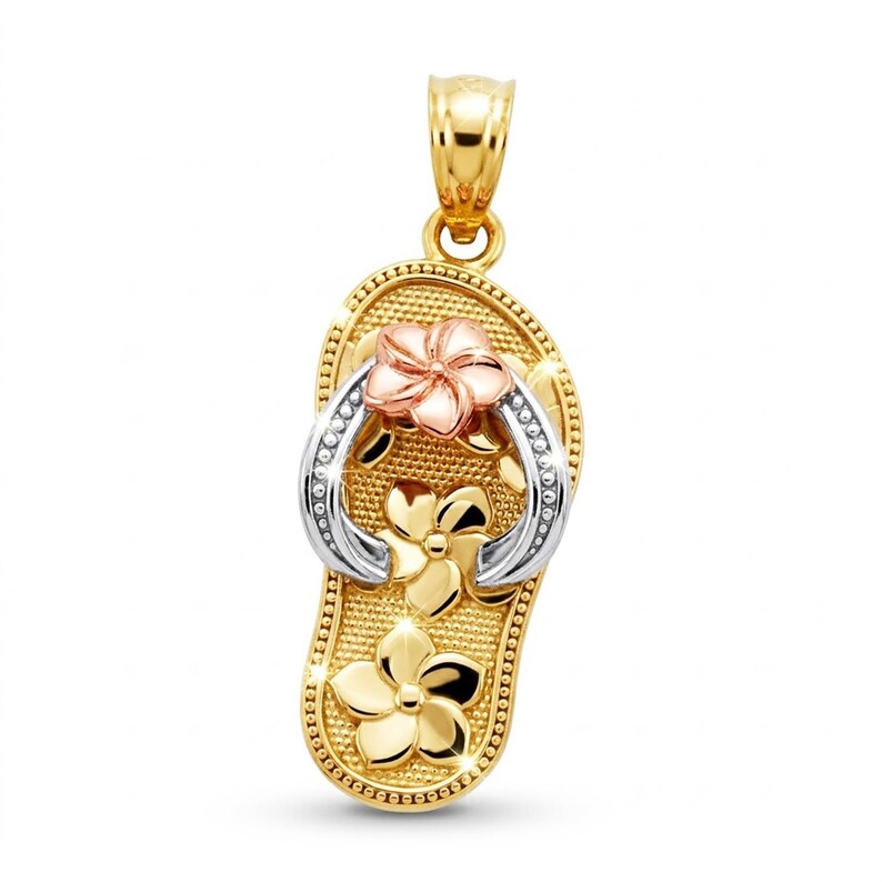 May include: A gold-tone pendant in the shape of a flip-flop, featuring a flower design. The pendant has a textured surface and is adorned with a pink and white flower, and two gold flowers. The flip-flop's strap is silver-colored.
