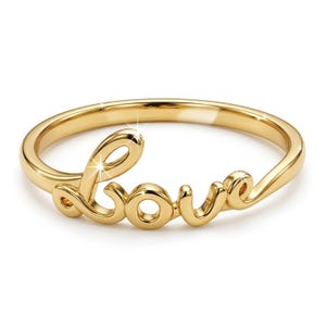 May include: A gold-colored ring with the word "love" in a cursive font. The ring is made of a shiny, polished metal and is set against a white background. The ring is a piece of jewelry.