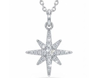 May include: A silver necklace with a starburst pendant. The pendant is adorned with many small, clear gemstones, giving a sparkling appearance. The chain is fine and matches the pendant's design. The necklace is likely made of a metal alloy, such as silver.