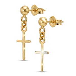 May include: A pair of gold stud earrings. Each earring has a small, round stud connected to a chain, suspending a cross pendant. The earrings are made of 10K gold.