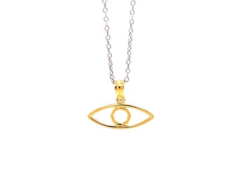 May include: A gold chain necklace with an eye-shaped pendant. The pendant is made of two thin gold wires that form the outline of an eye. The eye is hollow and has a small circle in the center.