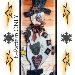 以下が含まれることがあります： 黒いシルクハット、赤いリボン、そして「ようこそ」という文字が書かれたハートが描かれた木製の雪だるまのクラフトパターン。パターンは木製の背景に描かれています。