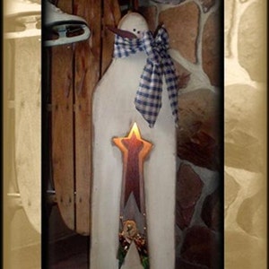 May include: A white wooden snowman with a blue and white plaid scarf and a star-shaped cutout with a red and orange glow. The snowman is standing on a wooden surface and has the word "Believe" written on the bottom. The image is labeled "E-Pattern ONLY".