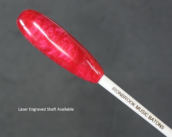 May include: A red and white conductor's baton with a swirl pattern on the top. The shaft is white with the text "IRONBROOK MUSIC BATONS" printed on it. Laser Engraved Shaft Available.