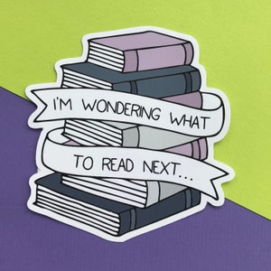 May include: A white sticker with a stack of books and a banner that reads "I'm wondering what to read next..." The books are purple, gray, and white.