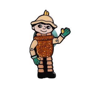 May include: A cartoon character pin with a brown glitter pot belly, a yellow hat, and green gloves. The character is waving with its right hand.