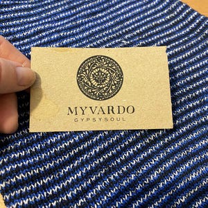 May include: A brown card with a black circular design and the text "MYVARDO GYPSYSOUL".