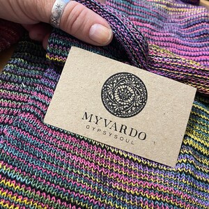 May include: A brown business card with the text "MY VARDO GYPSY SOUL" and a circular logo with a floral design.