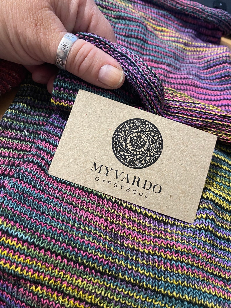 May include: A brown business card with the text "MY VARDO GYPSY SOUL" and a circular logo with a floral design.