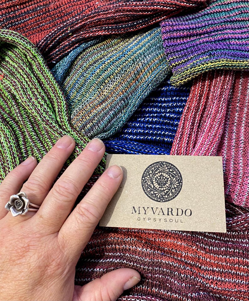 May include: Assortment of colourful striped knit fabric swatches with a business card that reads "Myvardo GypsySoul".