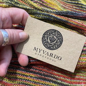 May include: A brown business card with a black circular logo and the text "MY VARDO GYPSY SOUL".