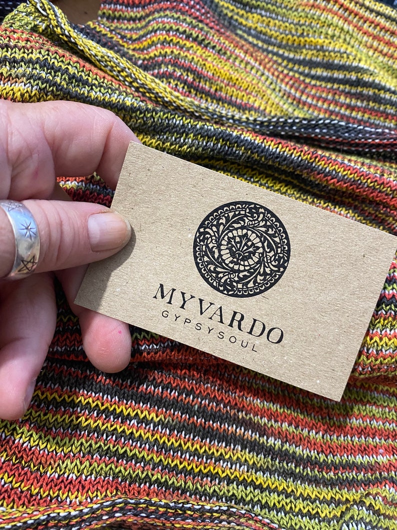 May include: A brown business card with a black circular logo and the text "MY VARDO GYPSY SOUL".