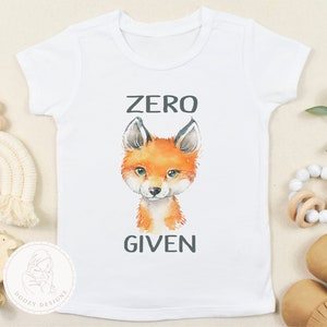 May include: White baby onesie with a fox illustration and the text "ZERO GIVEN" in black.